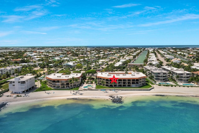 bird's eye view featuring a water view and a beach view