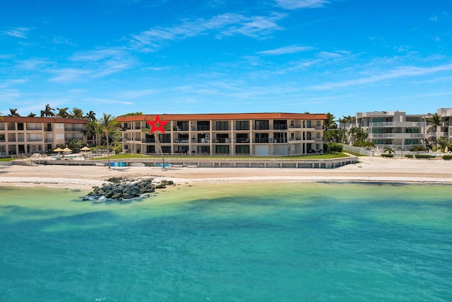 view of swimming pool with a view of the beach and a water view