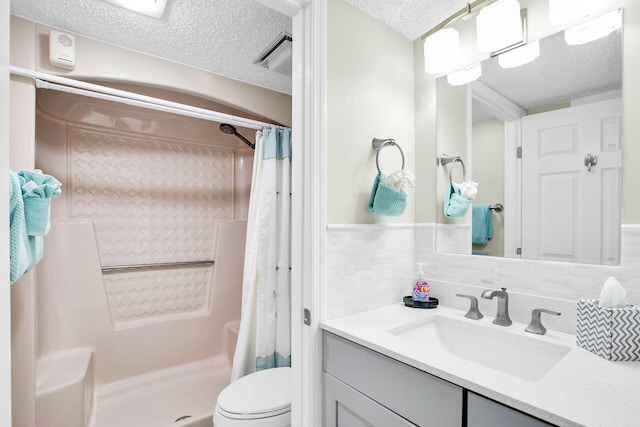 bathroom with vanity, toilet, a textured ceiling, and a shower with curtain