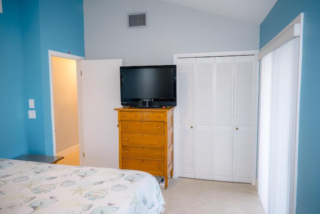 bedroom with lofted ceiling, a closet, and visible vents