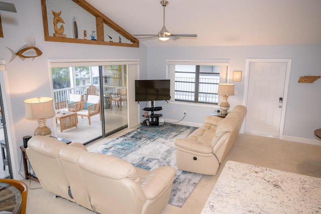 living room featuring vaulted ceiling, a ceiling fan, and baseboards