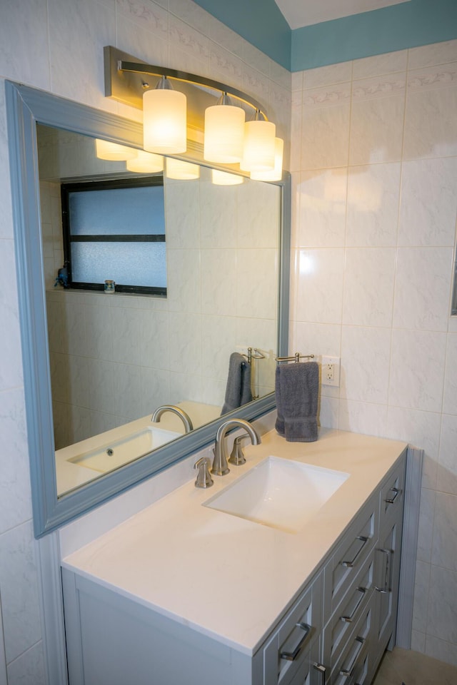 bathroom with tile walls and vanity