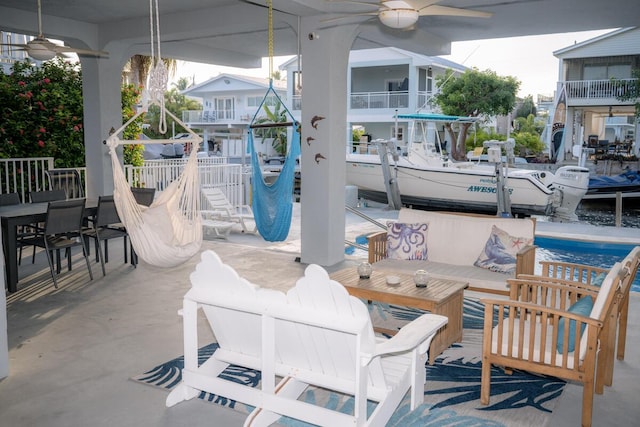 view of patio / terrace featuring ceiling fan and fence
