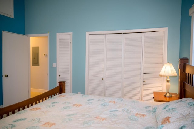 bedroom with electric panel and multiple closets