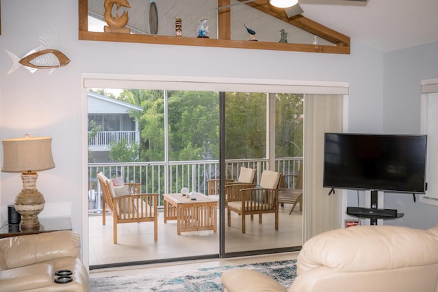 living room featuring vaulted ceiling and tile patterned floors