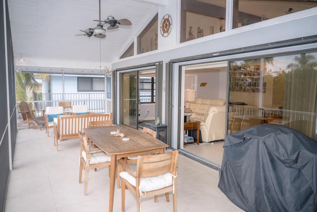 sunroom featuring ceiling fan and lofted ceiling