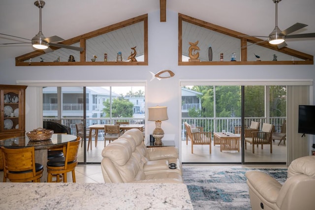 living room featuring ceiling fan, high vaulted ceiling, light tile patterned flooring, and beam ceiling