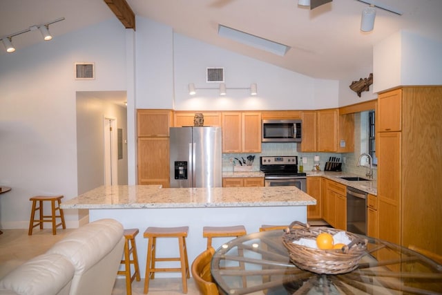 kitchen featuring backsplash, visible vents, stainless steel appliances, and a sink