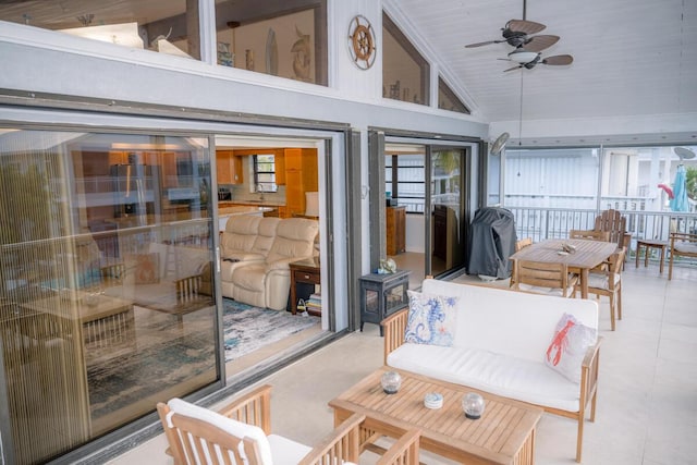 sunroom with vaulted ceiling and ceiling fan