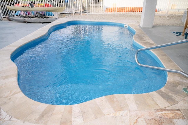 view of pool featuring a patio area, fence, and a fenced in pool