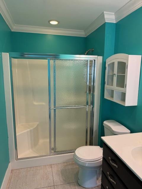 bathroom featuring a shower with door, crown molding, and vanity