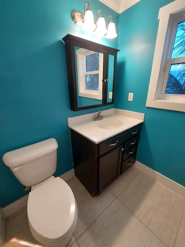 bathroom with tile patterned flooring, vanity, and toilet