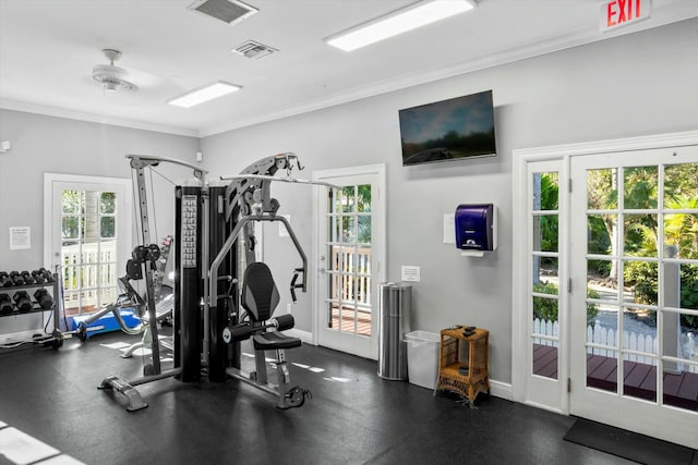 workout area featuring ornamental molding, visible vents, and baseboards