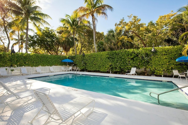 pool featuring a patio area and fence