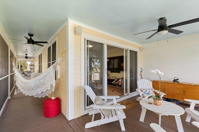 wooden terrace featuring ceiling fan