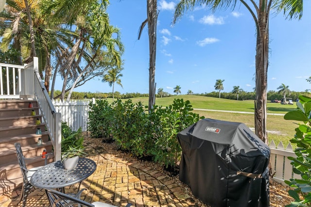 view of patio / terrace featuring a grill and fence