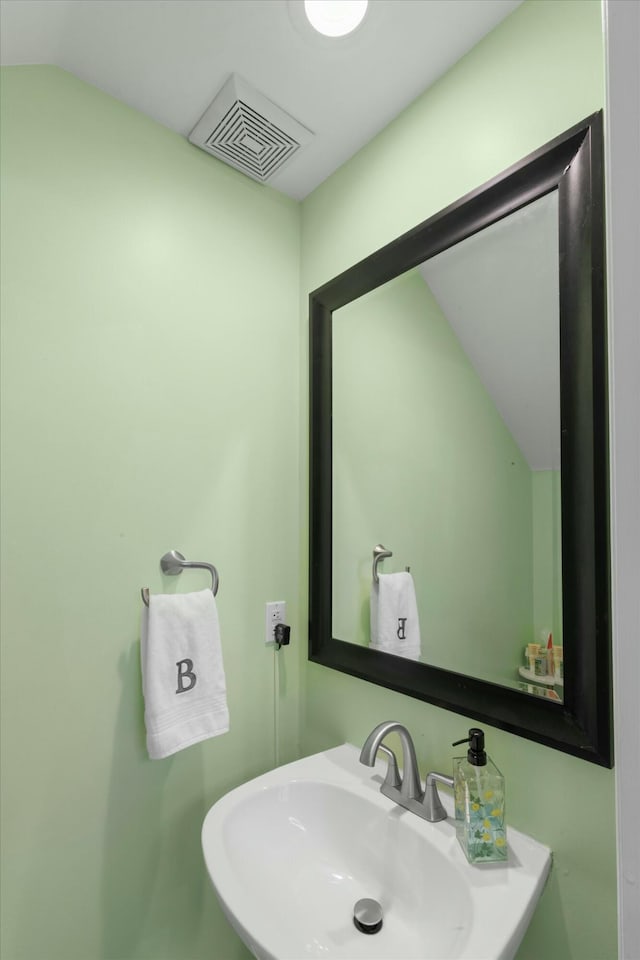 bathroom with visible vents and a sink