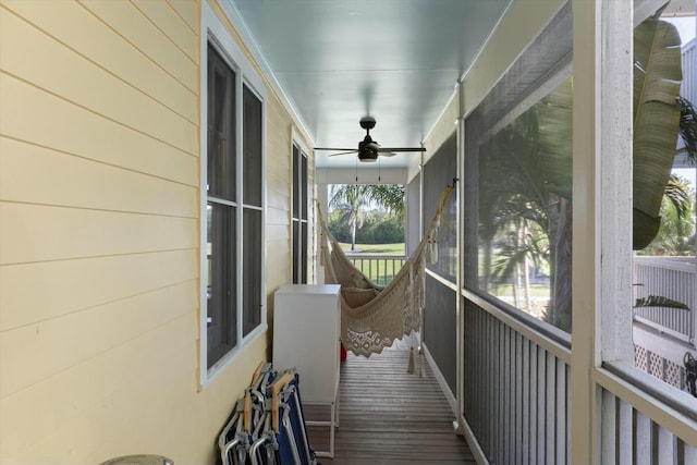 sunroom featuring ceiling fan