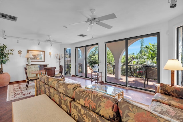 living area with visible vents, ceiling fan, track lighting, and wood finished floors