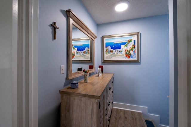 office space featuring dark wood finished floors, baseboards, and a textured ceiling