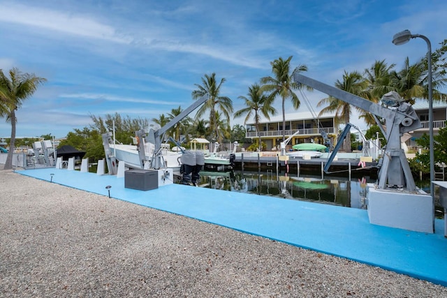 dock area with a water view and boat lift