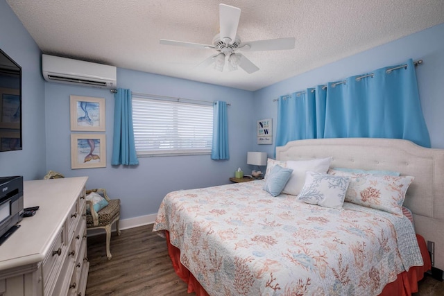 bedroom featuring baseboards, ceiling fan, an AC wall unit, dark wood-type flooring, and a textured ceiling