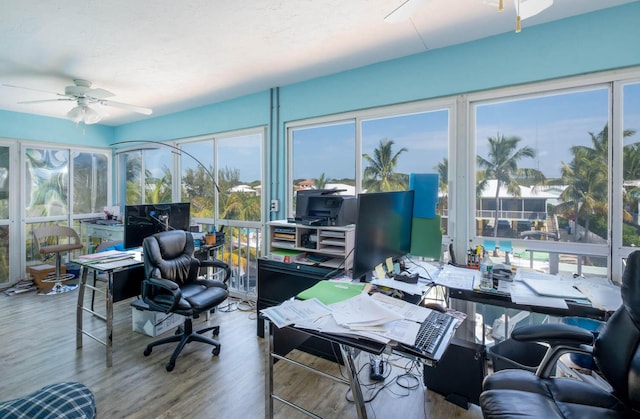 home office featuring wood finished floors and ceiling fan