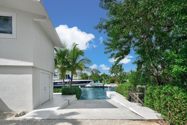 view of pool featuring a patio and a water view