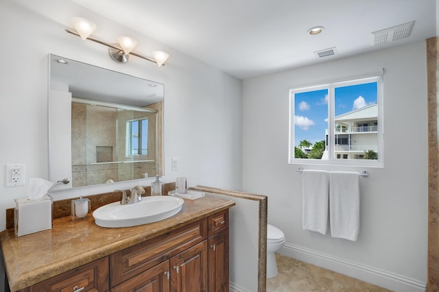 bathroom with vanity, tile patterned floors, toilet, and walk in shower