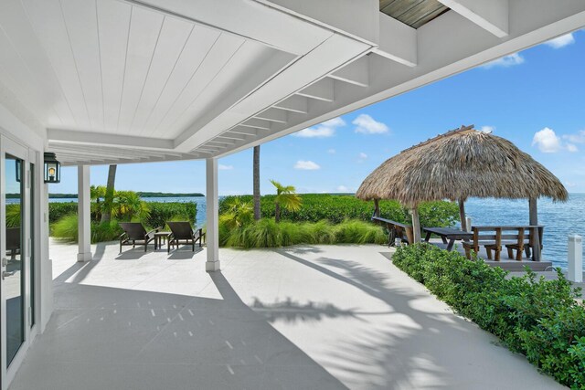 view of patio with a gazebo and a water view