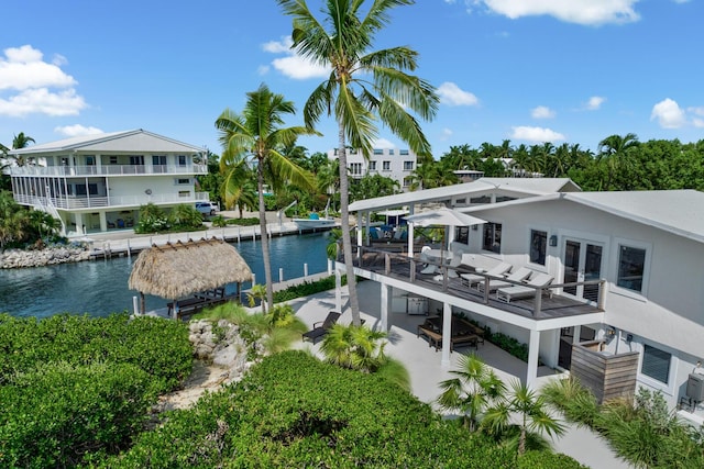 exterior space with a patio area, a balcony, and a water view