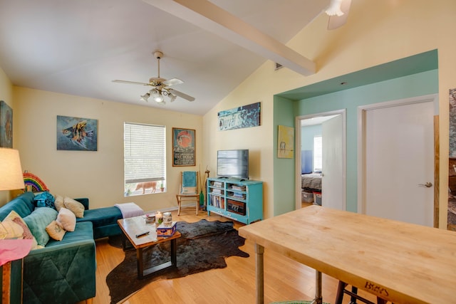 living room with wood-type flooring, lofted ceiling with beams, and ceiling fan