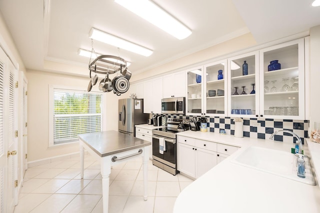 5960 Peninsular Ave Unit 101, Stock Island, FL 33040 - kitchen with stainless steel appliances, tasteful backsplash, a chandelier, a sink, and white cabinets