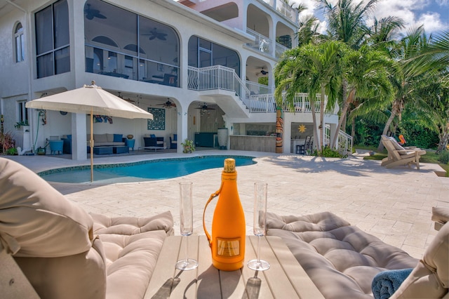 view of swimming pool featuring outdoor lounge area, a patio, and ceiling fan