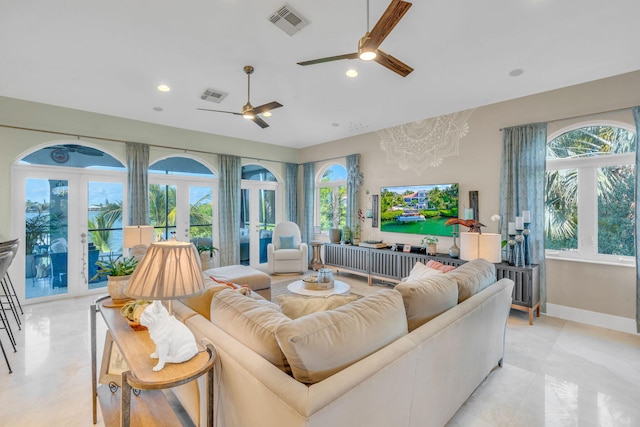 living room featuring french doors and ceiling fan