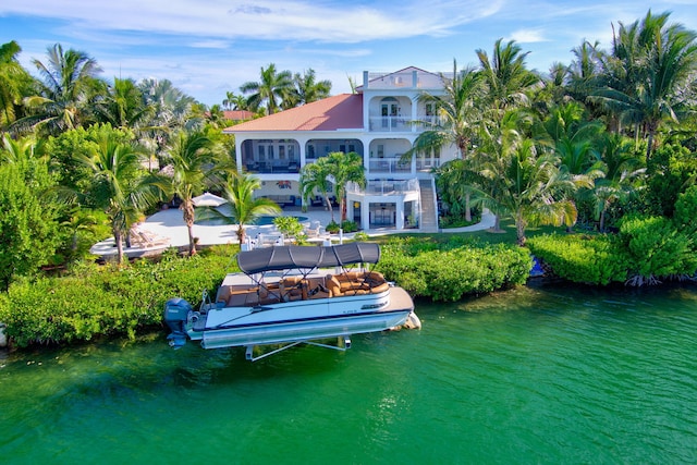 exterior space featuring a balcony and a water view