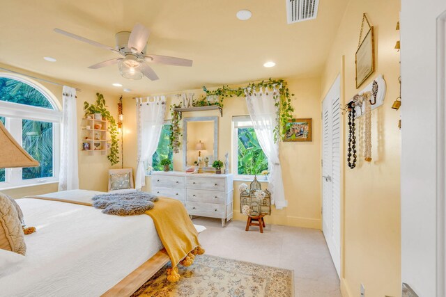 bedroom featuring multiple windows, light tile patterned floors, and ceiling fan