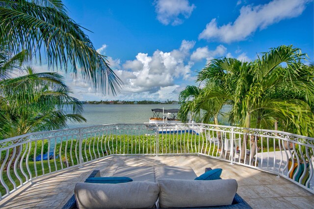 view of patio featuring a balcony and a water view