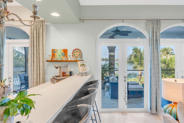 doorway with french doors and ceiling fan