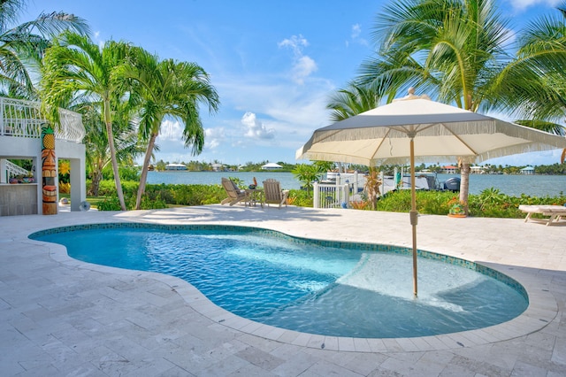 view of swimming pool featuring a patio and a water view