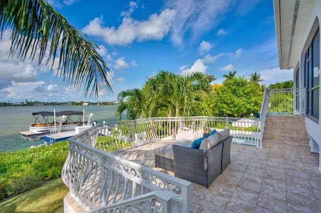 view of patio / terrace featuring a fenced in pool, a water view, and a dock