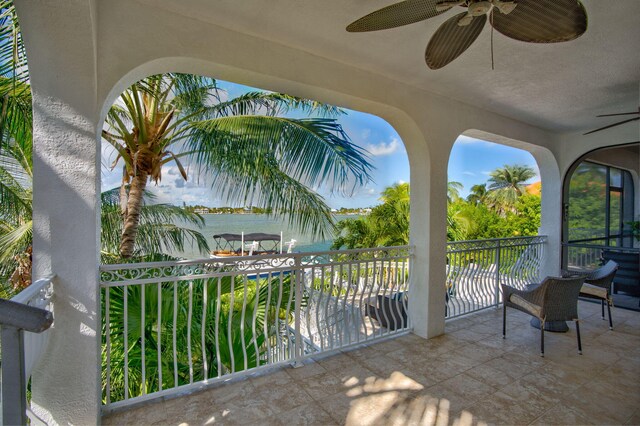 view of patio with a balcony and ceiling fan