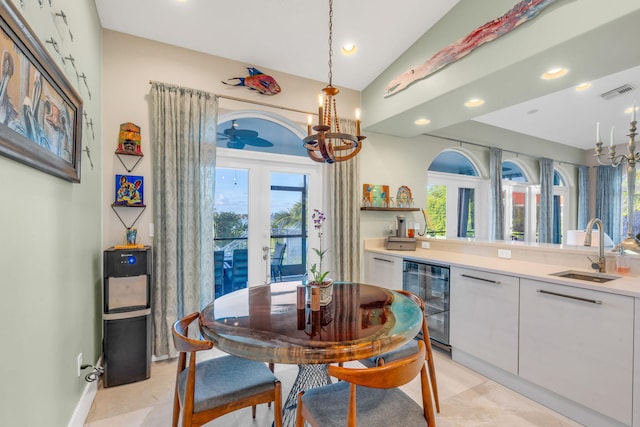 dining area featuring sink, vaulted ceiling, beverage cooler, and french doors