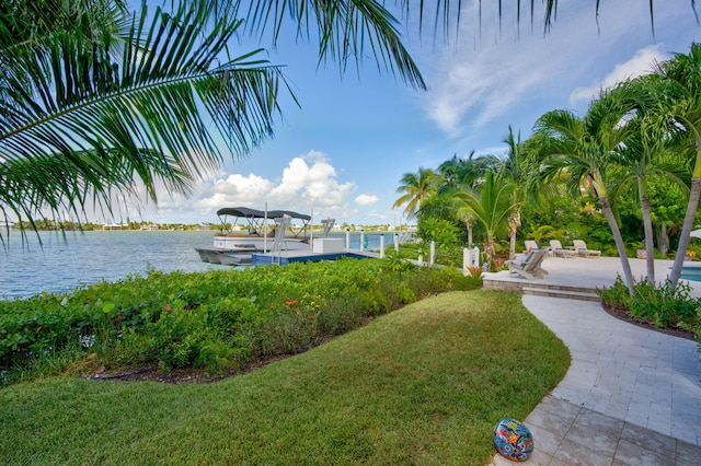 exterior space featuring a water view, a dock, and a patio area