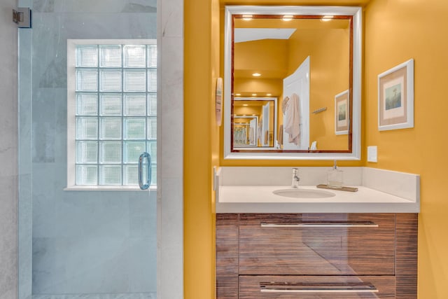 bathroom featuring vanity and an enclosed shower