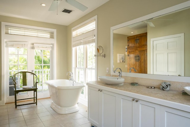 full bathroom featuring ceiling fan, tile patterned flooring, vanity, visible vents, and a soaking tub