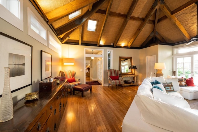 living room with a skylight, wood ceiling, wood finished floors, beamed ceiling, and high vaulted ceiling