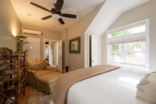 bedroom with a ceiling fan, lofted ceiling, and a wall mounted air conditioner