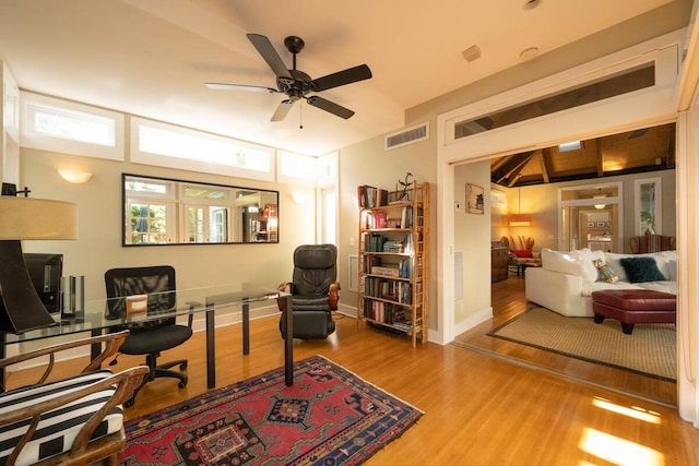 home office with baseboards, wood finished floors, visible vents, and a ceiling fan