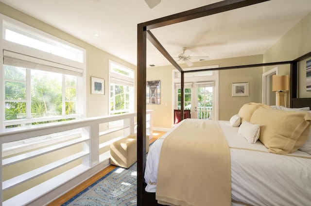 bedroom featuring access to exterior, multiple windows, and a ceiling fan